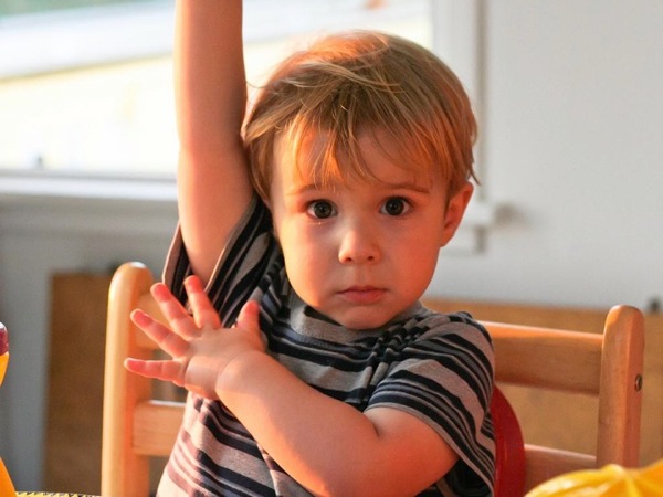 Image of a child raising his hand