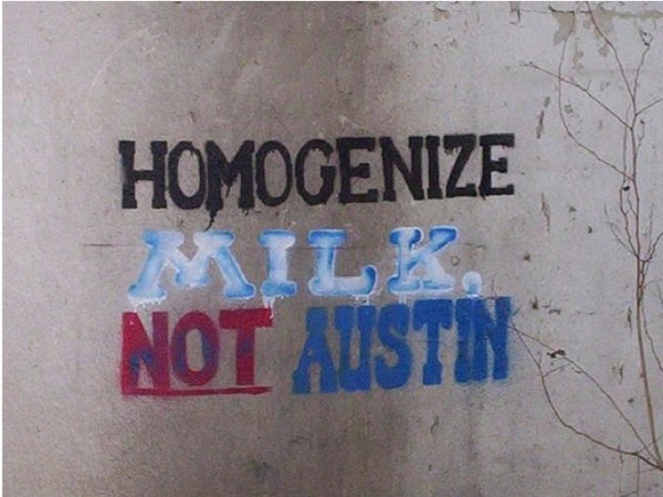 Photo of graffiti that reads: Homogenize Milk, Not Austin
