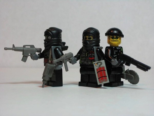 Photograph of three LEGO minifigs dressed as thieves